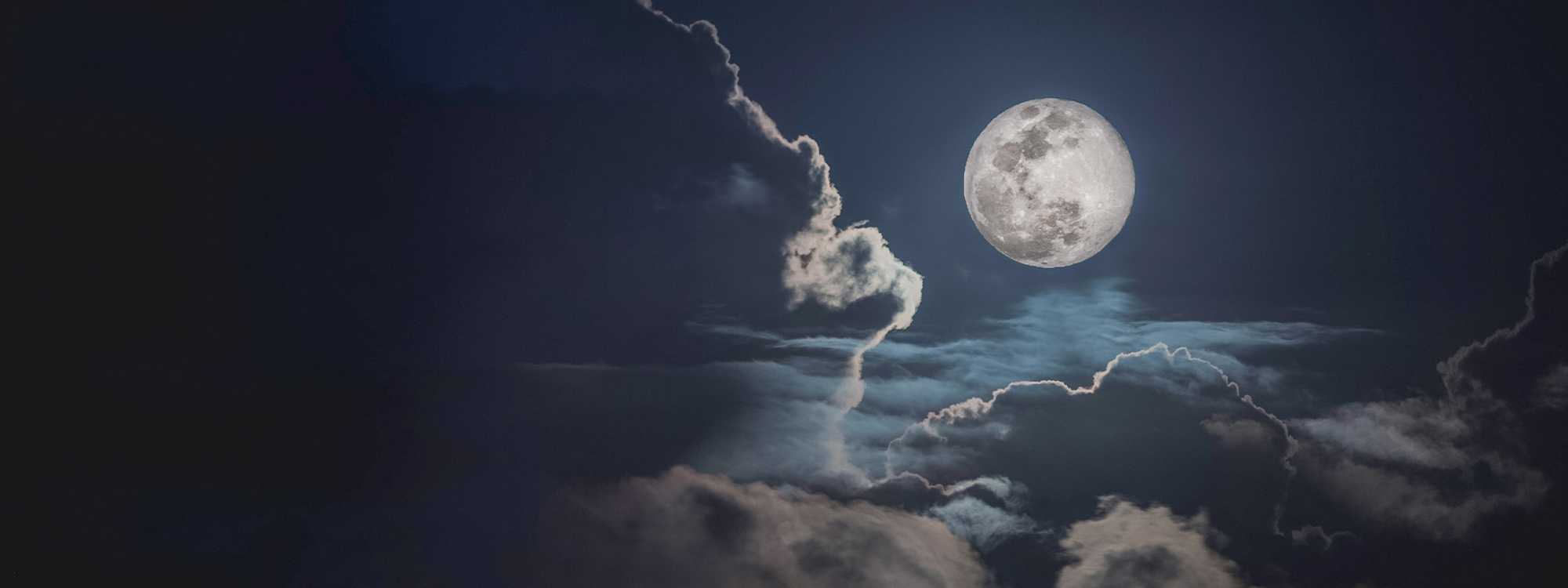 Moonlight shining through clouds at night
